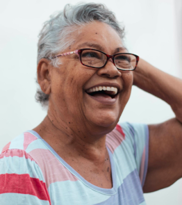 A woman with glasses smiling