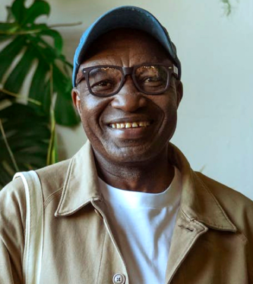 a male with a jacket smiling
