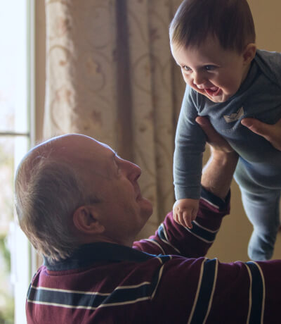 A man holding a smiling baby